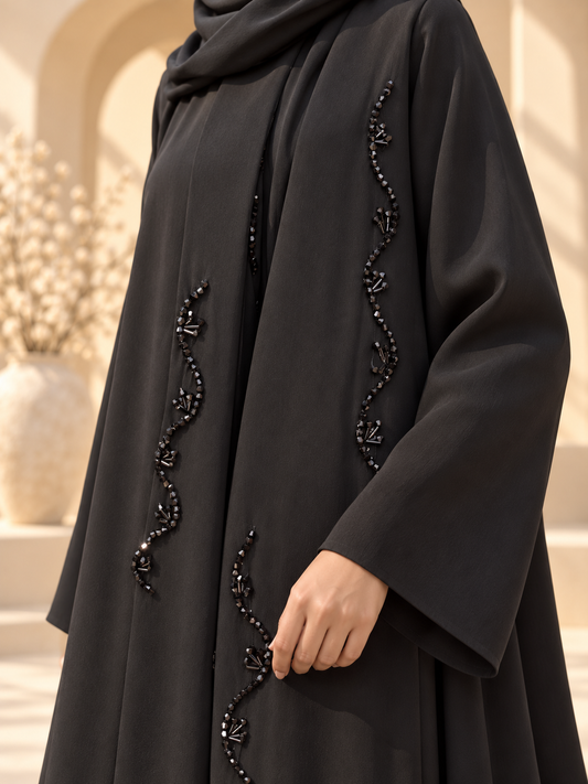 Lehar Beadwork Abaya — wavy beadwork detail in sunlit courtyard