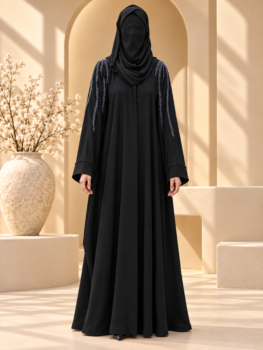 Aabshar Beadwork Shoulder Abaya — front in sunlit courtyard